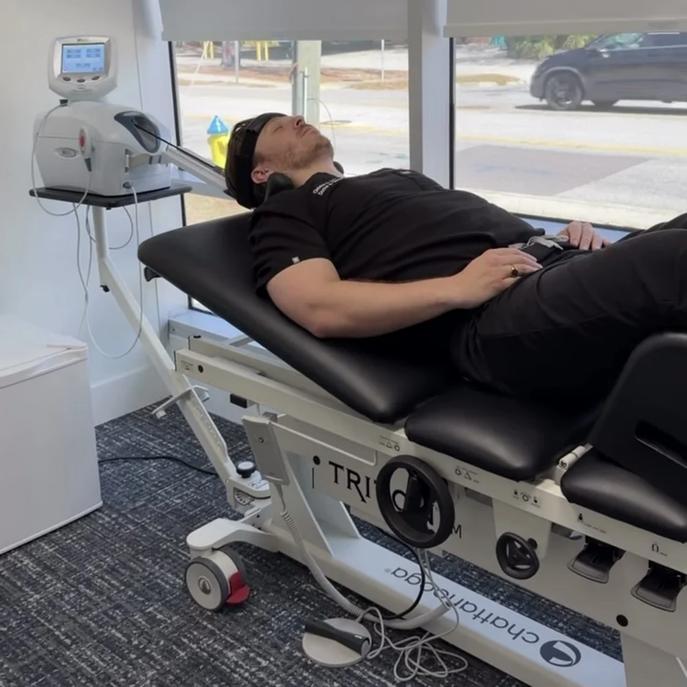 Patient receiving non-surgical spinal decompression on the Triton DTS table